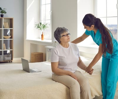 Cherokees Angel Personal Care Home, Nursing Home in Canton, GA — Caregiver assisting a senior resident in a cozy room