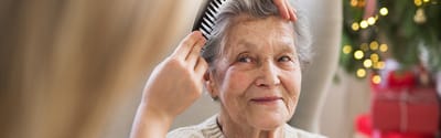 Cherokees Angel Personal Care Home, Nursing Home in Canton, GA — Elderly woman being groomed during a festive celebration