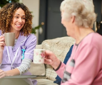 Cherokees Angel Personal Care Home, Nursing Home in Canton, GA — Caregiver and resident enjoying tea together in a cozy setting