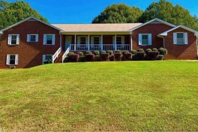 Cherokees Angel Personal Care Home, Nursing Home in Canton, GA — Brick building with a front porch and manicured lawn