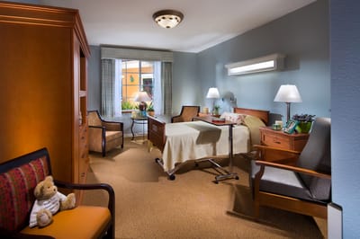 Cozy resident room with a bed and sitting area