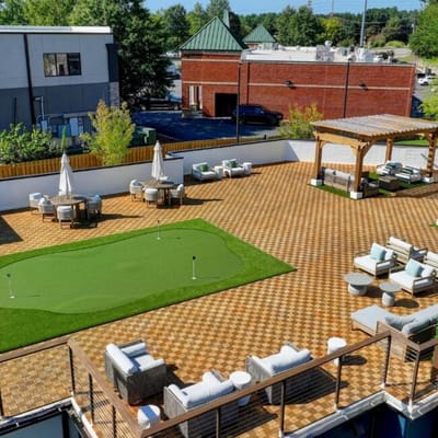 Outdoor space with seating and putting green