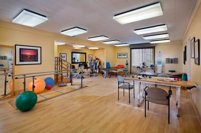 Physical therapy room with equipment and exercise balls