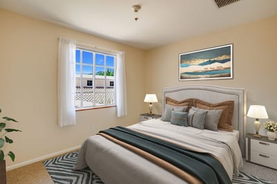 Brightly decorated resident bedroom with natural light