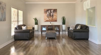 Height Street Skilled Care, Nursing Home in Bakersfield, CA — Cozy lounge area with leather sofas and artwork