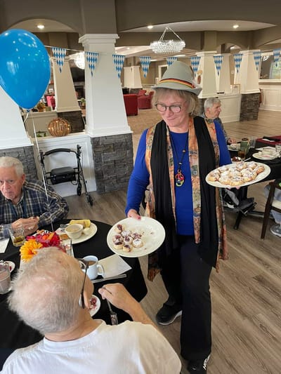 Staff serving food to residents during an event