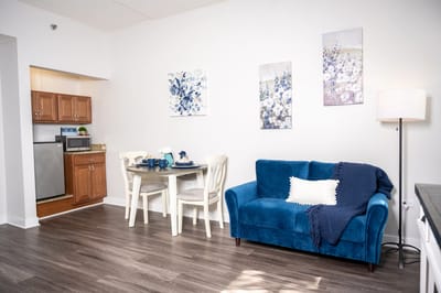 Cozy living space with a blue couch and dining area