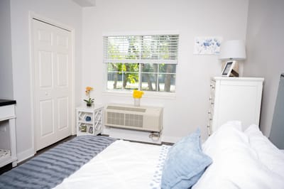 A cozy resident room with a bed and window