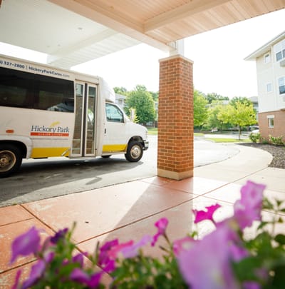 Facility shuttle van parked near entrance