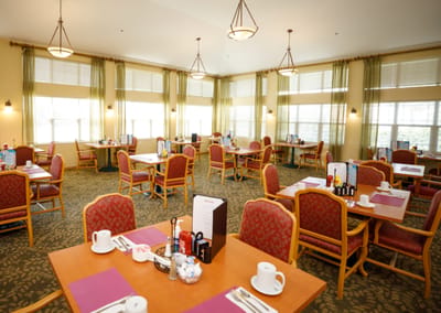 Bright dining room with tables set for meals