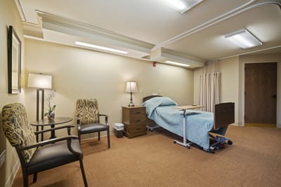 Private resident room with a bed and seating area