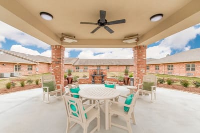 Outdoor patio area with seating and landscaping