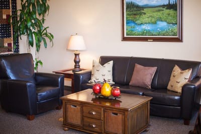 Cozy common area with seating and decorative painting