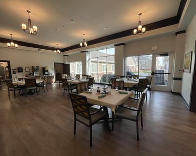 Dining room with tables and chairs set for a meal
