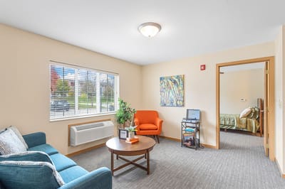 Cozy resident room with a seating area and natural light