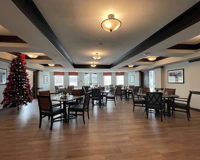 Interior view of a decorated common area with festive tree