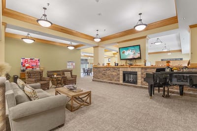 Common area with seating and piano in bright interior