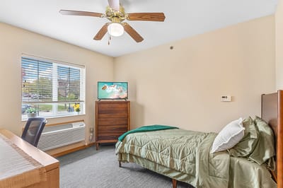 Private resident room with a bed and TV