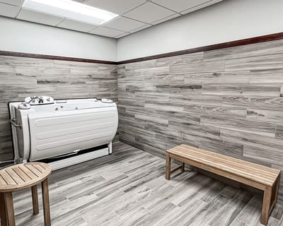Interior view of a wellness area with a tub and wooden bench