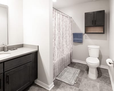 A modern bathroom with a shower and vanity