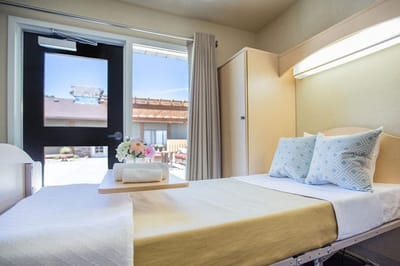 A neatly arranged resident room with a view