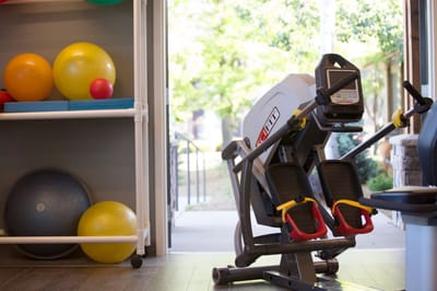 Fitness equipment in a well-lit exercise room