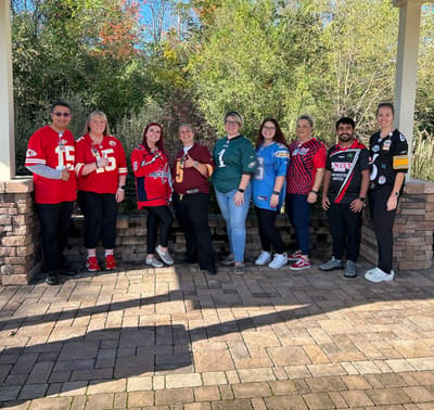 Staff members wearing jerseys in an outdoor space