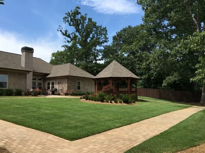 Outdoor view of a senior care facility with gazebo and gardens