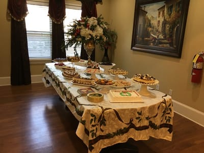 A table filled with various decorated cakes and desserts