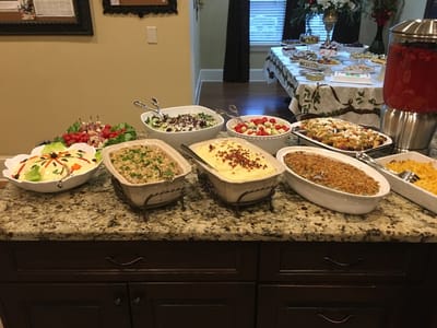 A table filled with various dishes and salads.