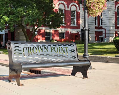 Decorative bench with 'Crown Point' inscription outside