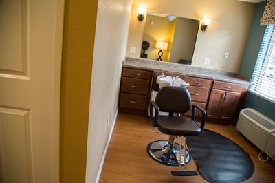 Hair salon area with styling chair and mirror