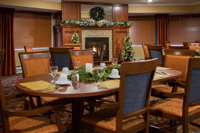 Dining room with decorated tables and a fireplace
