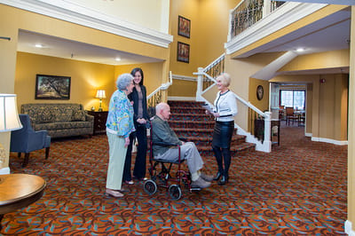 Residents and staff interacting in a welcoming lobby