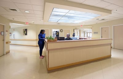 Reception area with staff assisting visitors