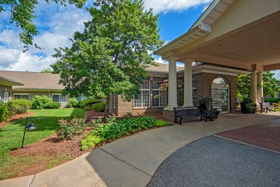 Entrance to a senior living facility with landscaped gardens