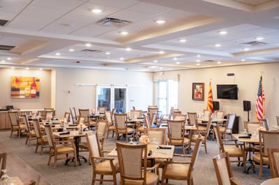 Bright dining room with tables set for residents