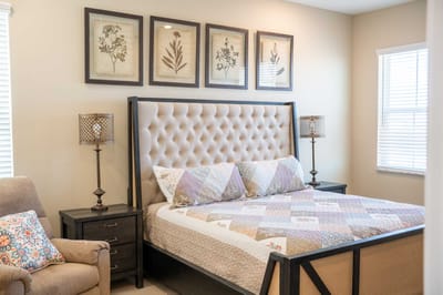 Cozy bedroom with decorative wall art and upholstered headboard