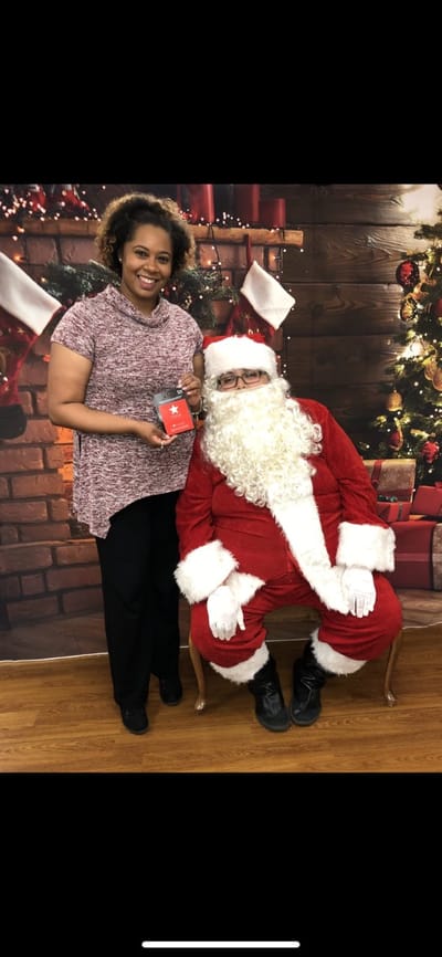 Resident and staff member celebrating Christmas with Santa