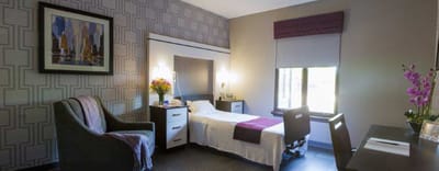 Cozy private resident room with bed and decor