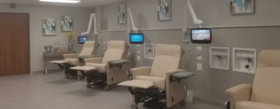 Interior room with recliner chairs and mounted screens