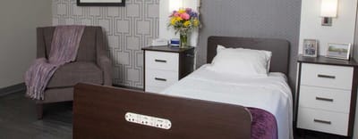 Cozy resident room with bed and floral decor