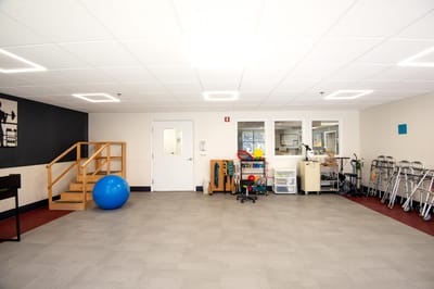 Physical therapy room with equipment and exercise tools