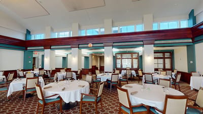 Interior view of a dining room with tables set for service