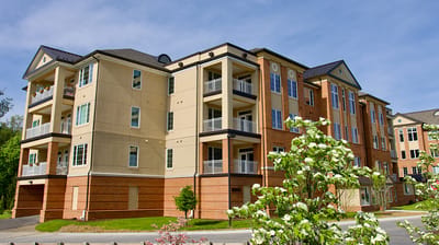 Exterior view of a senior living facility surrounded by greenery