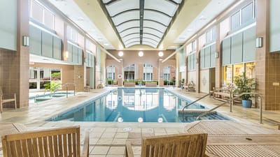 Indoor swimming pool area with lounge chairs