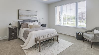A well-furnished resident room with a bed and seating area