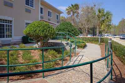 Accessible outdoor walkway with landscaping and railings