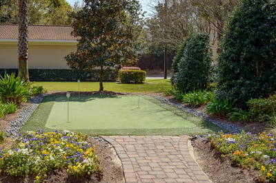 Garden area with a putting green surrounded by flowers