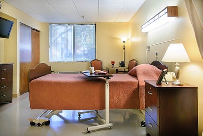 A private resident room with a bed and furniture